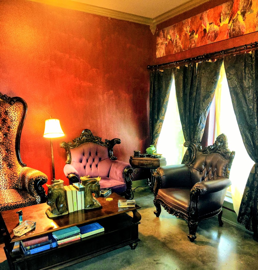 Antique tufted chairs and a coffee table in the cigar lounge at RNA Tavern