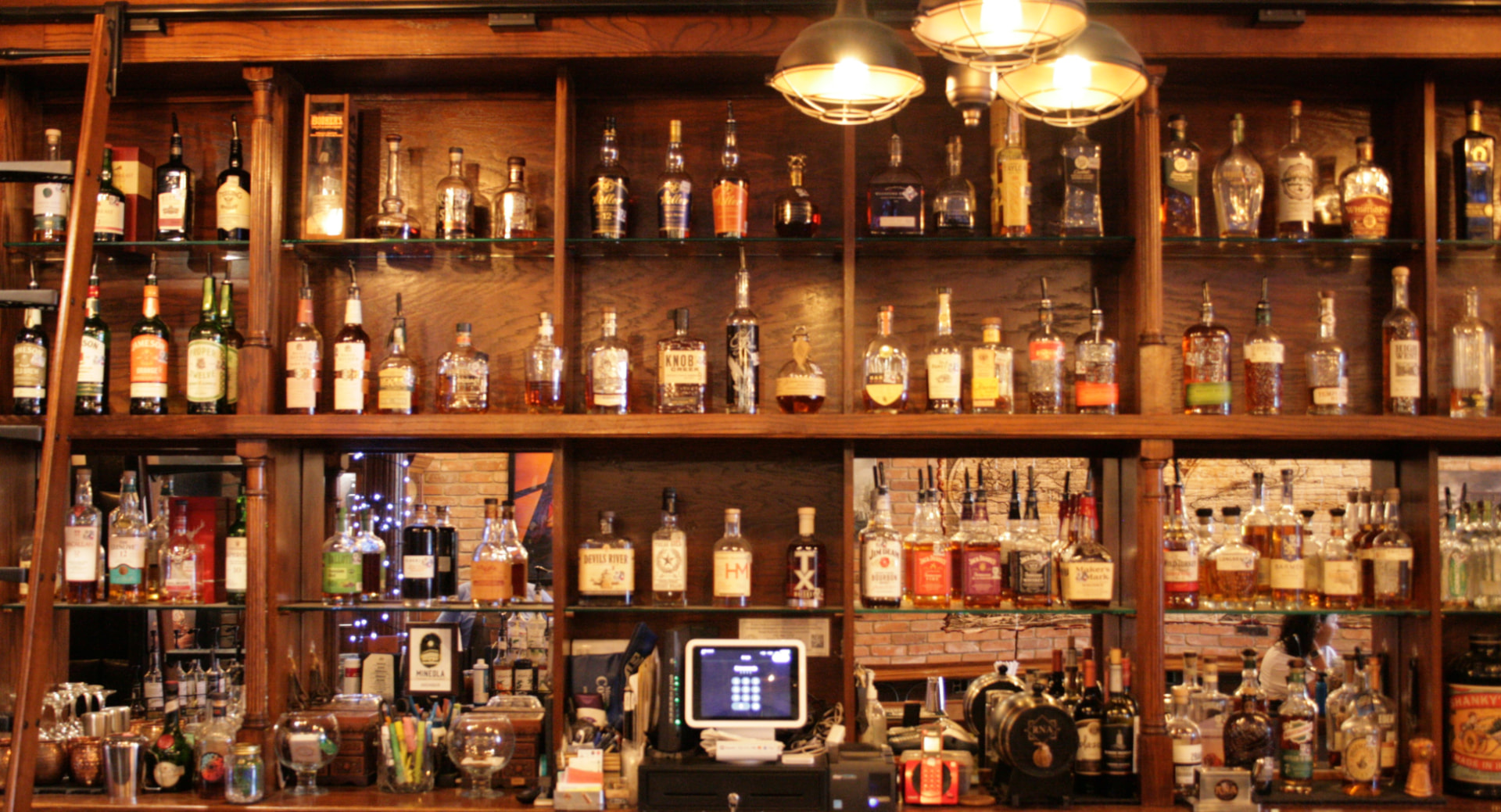 The back bar at RNA Tavern in Mineola, Texas, stocked with whiskey and tequila